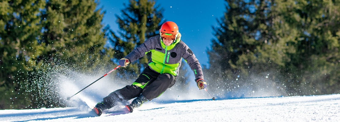 Skier carving a turn on a ski slope in Montenegro