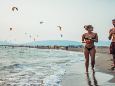 People walking along Velika Plaza beach in Ulcinj, Montenegro