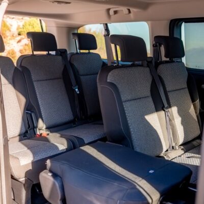 Interior of a Toyota Proace Verso passenger van with multiple seats, operated by LAZEX TRANSFER.